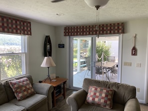 Living room with great sliding door leading to the covered lakefront deck