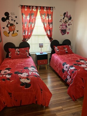 Mickey / Minnie Mouse room - two twin beds.  Ears headboards.  