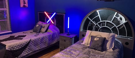 Star Wars room - two twin beds.  Lightsaber table lamp and flat screen TV.