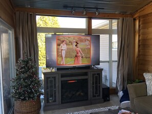 Sunroom electric fireplace and large smart flat screen TV