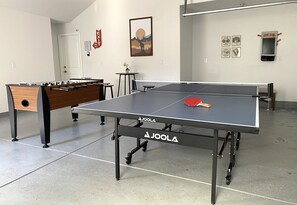 Game room with a ping pong table and foosball.