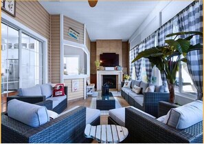 Sun Room - Bright and airy living space  with fire place and TV