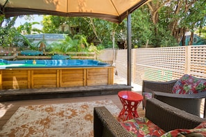 Shady backyard oasis with swim spa tub, easily spacious enough for 8 adults