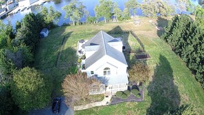 Aerial view of property- river, dock, pergola , pool behind house
