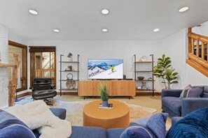 Enjoy modern decor, a warm gas fireplace, and a big-screen TV in this spacious living room designed for comfort