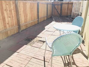 Backyard with two chairs to enjoy some sunshine or chill at the end of day.