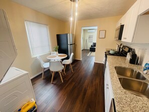 Fully stocked kitchen with washer and dryer.