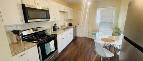 Fully stocked kitchen with washer and dryer.