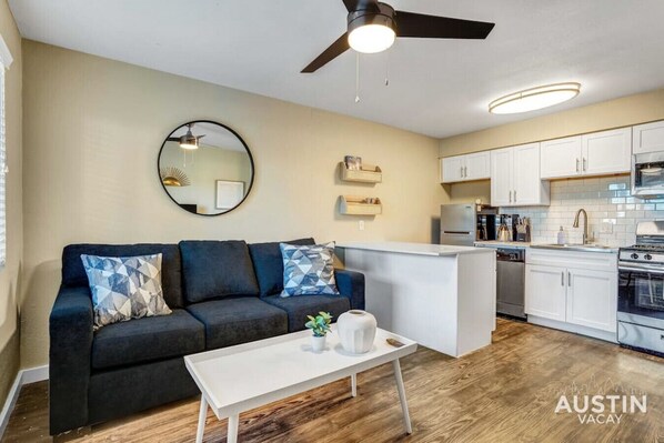 Living room with sleeper sofa and open concept kitchen with island