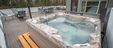 Enjoy your own private outdoor oasis with hot tub, fire pit, dining and lounges 