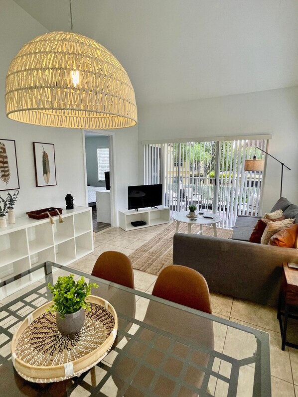 Open concept living and dining room overlooking community pool