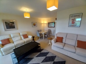 The comfortable first floor Dining Sitting Room with two 3 seater sofas and a TV