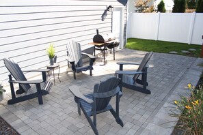 Back patio w bbq and four Adirondack chairs