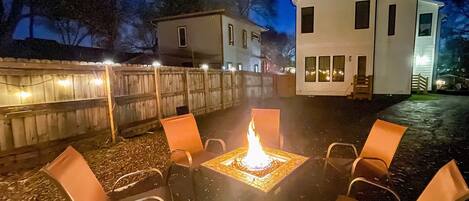 Private fireplace in the back of fenced in driveway