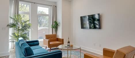 Chic modern living room with cozy furniture and a smart TV!