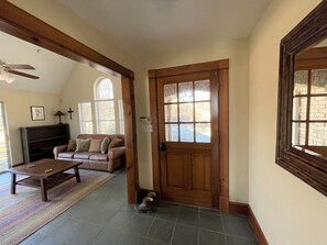 front door leading into living area (left), and bedrooms (behind, out of frame)
