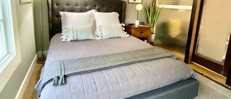 Queen sized mattress with padded headboard and high quality linens