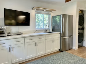 New kitchen. cuisinart oven, cooktop, microwave, full size refrigerator.