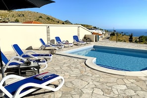 Large heated pool and comfortable sun loungers