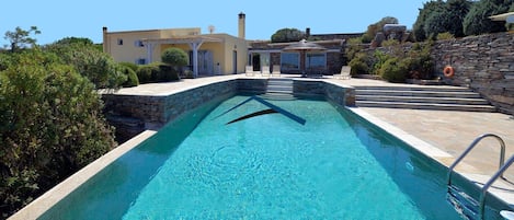 Large swimming pool with the villa in the background