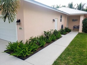 Walkway leading from driveway to side garage door and front door entryway.