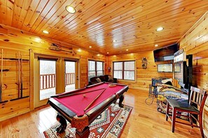 Game room with pool table and arcade games in the basement that both kids and adults will love in the basement.