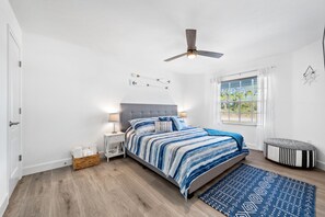 Blue master bedroom with TV