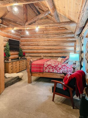 Large bedroom with log cabin feel.
