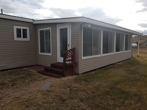 back of home, standing where you park, looking at the door you walk in. 