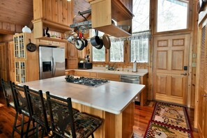 Kitchen has full size appliances and an island snack bar.
