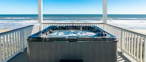 Unwind after a day in the sun in the private hot tub overlooking the Gulf