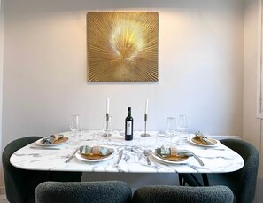 Dining table doubles as a work desk, seating four comfortably.