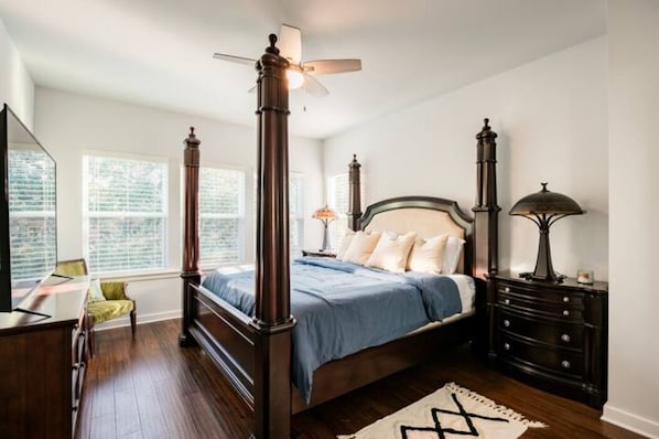 Master Bedroom has a king bed, 2 night stands, a ceiling fan & large smart t.v.