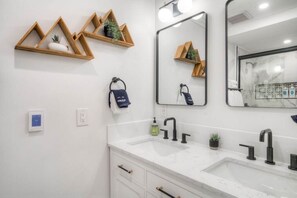 Indulge in the timeless bathroom with shower, double vanity and heated floors