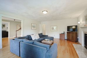 Living Room 1:  Large sectional couch, flat-screen TV, and fireplace.
