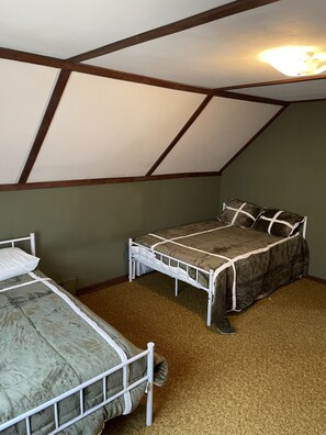 Upstairs bedroom with two double beds