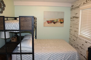 Second bedroom with full size bed and single bed. Looks out over the bay.
