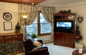 Living room font window and TV.