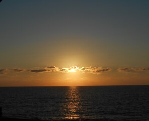 Sunset over Coral Bay, view from balcony.