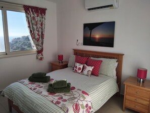 Double bedroom adjacent to bathroom, safe deposit box, hair dryer.