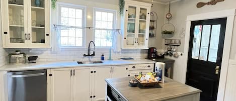 Charming kitchen with original cabinets yet with all of the modernized touches.