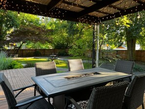 Covered Fire Dining table for 6. Edison lights. A perfect gathering place.