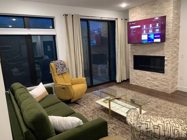 Family room featuring a large Roku TV over the gas fireplace.