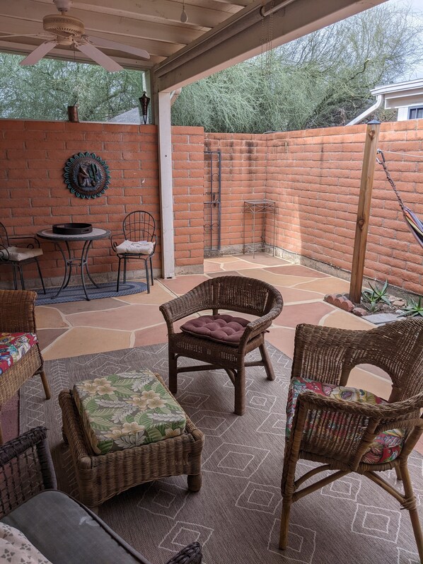 Private patio with six foot brick wall and stone floor for barefoot relaxation