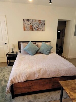 Queen Bed with 100% cotton bedding and light down comforter inside cotton duvet