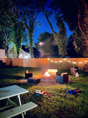 Backyard with propane grill, fire pit, corn hole & picnic table