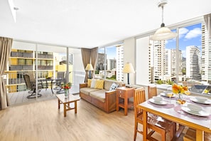 Spacious living room with pull-out sleeper sofa, and coffee table, and dining table with 4 chairs.
