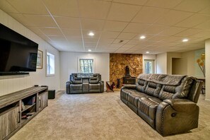 Downstairs lounge area complete with two couches (one is a queen size sleeper sofa) and a love seat to watch the large flat screen TV.

Please note: wood burning stove in the background is not functional.