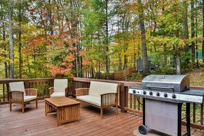 Back deck with lounge furniture and propane gas grill.