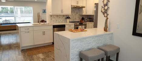 Chef’s kitchen
-updated appliances, granite tops and bar stools on either side 